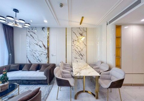 Modern living room and dining area interior design in Chandigarh featuring false ceiling, ambient lighting, luxury sofa setup, TV wall panel, dining table, and contemporary 3BHK apartment interiors.